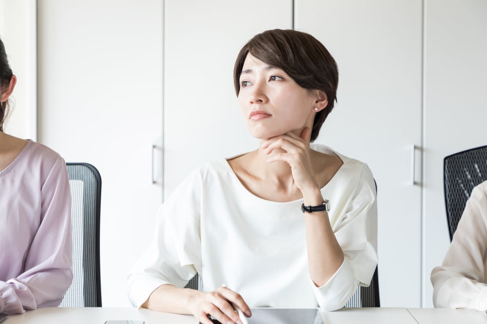 Thinking young woman in the office.; Shutterstock ID 1031349589